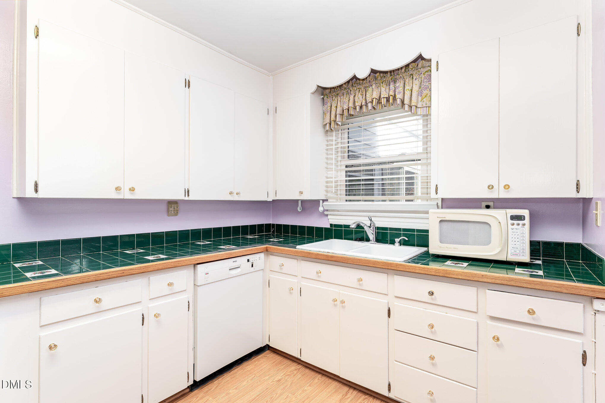113 West Riverside Drive Smithfield, NC 27577 - Photo 17 of 43 a kitchen with granite countertop white cabinets and white appliances