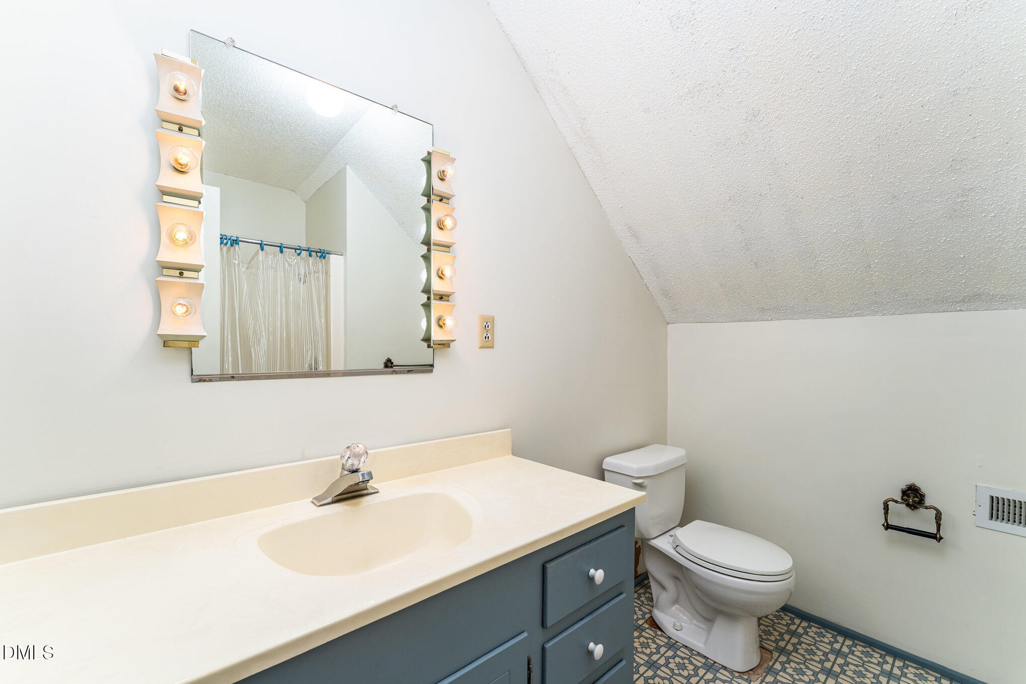 113 West Riverside Drive Smithfield, NC 27577 - Photo 26 of 43 a bathroom with a sink a toilet and mirror
