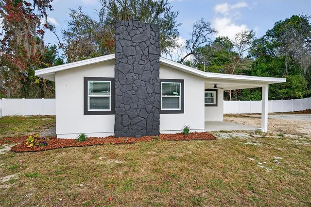 a house with trees in the background