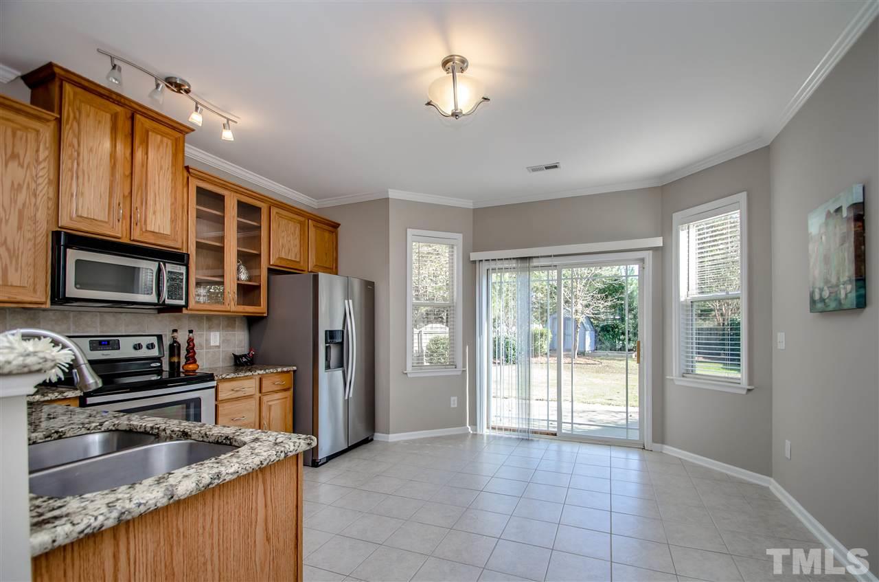 10805 Farmville Road Raleigh, NC 27614 - Photo 6 of 11 The kitchen opens up to the back patio and private backyard. Tons of NATURAL LIGHT flows freely into the space.