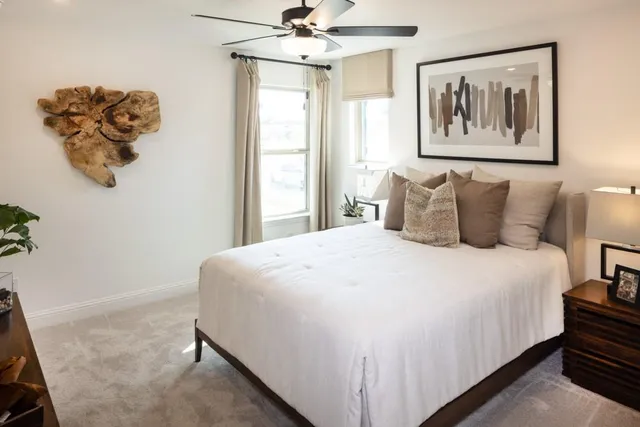 a bedroom with a large bed and a chandelier