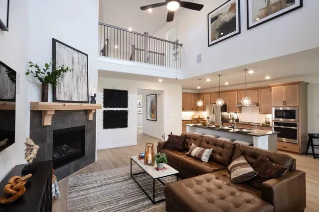 a living room with furniture kitchen view and a fireplace