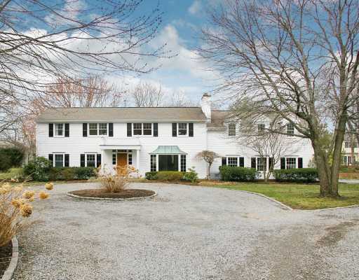 a front view of residential houses with yard and green space
