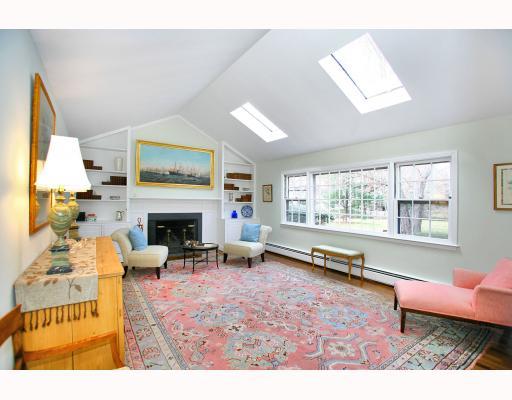 Undisclosed Address Darien, CT 06820 - Photo 3 of 10 a living room with furniture a large window and a fireplace