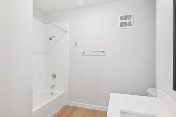 a bathroom with a bathtub and shower