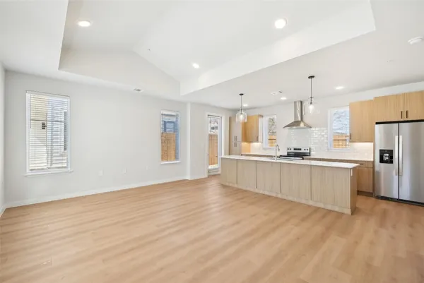 a large kitchen with a lot of counter space and stainless steel appliances