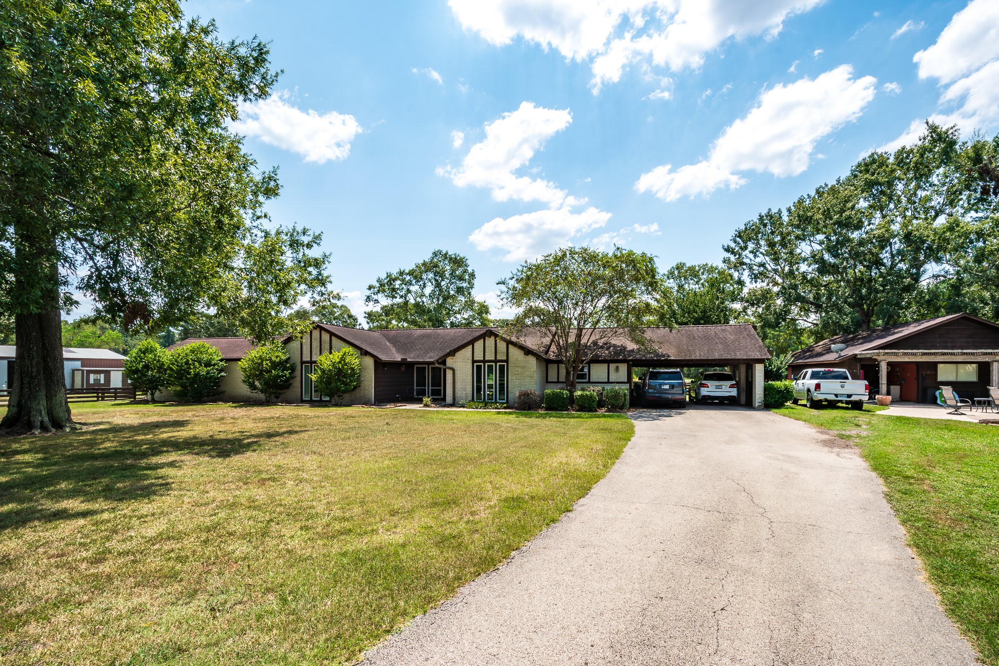 a front view of a house with a yard and trees