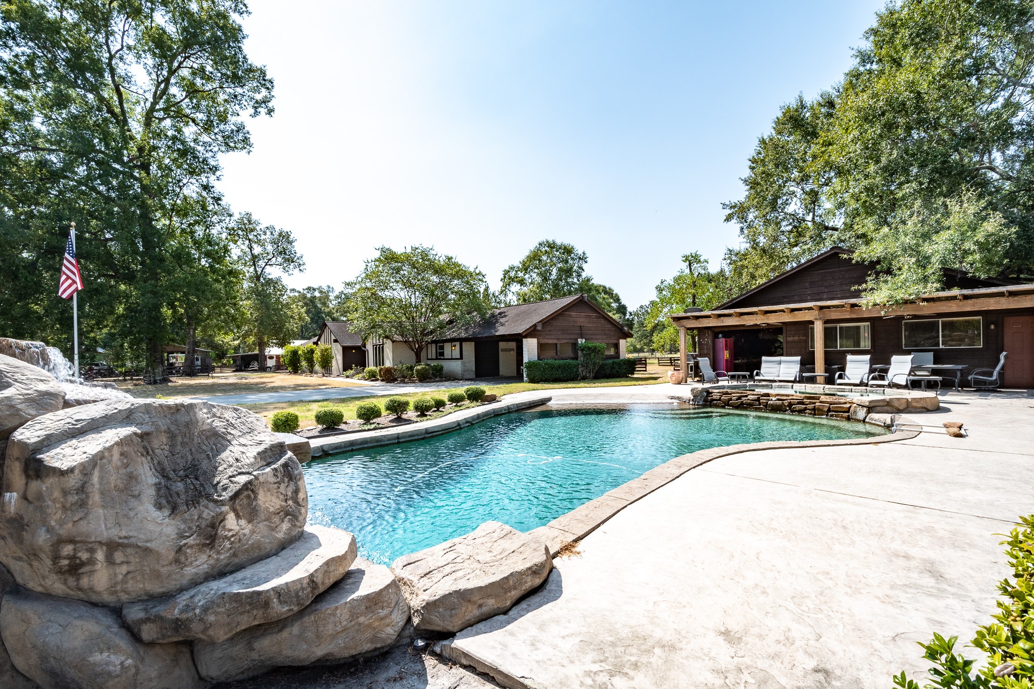 16410 Farm To Market 1485 Conroe, TX 77302 - Photo 18 of 47 a view of swimming pool with lawn chairs and plants