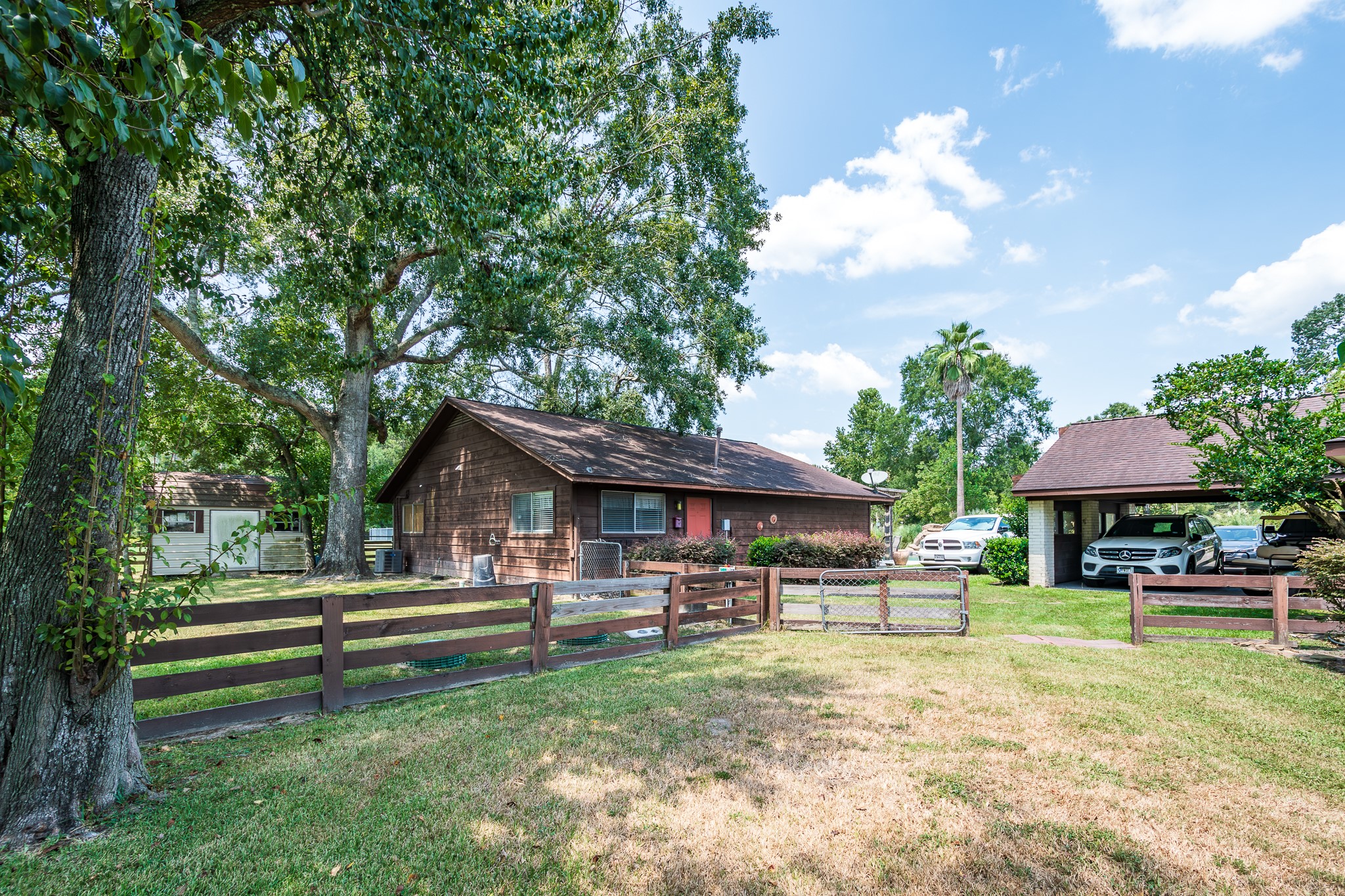 16410 Farm To Market 1485 Conroe, TX 77302 - Photo 21 of 47 a backyard of a house with barbeque oven table and chairs