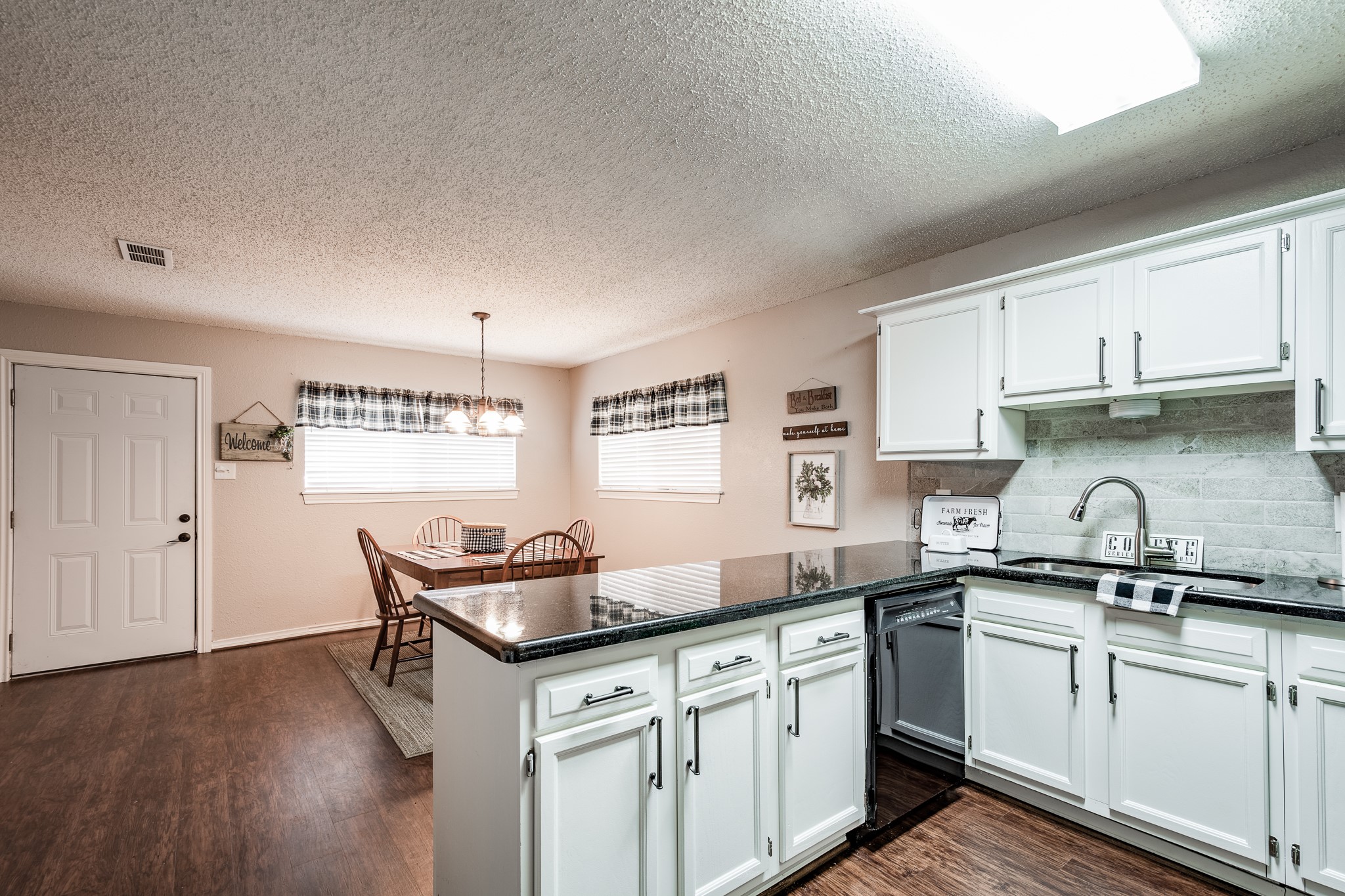16410 Farm To Market 1485 Conroe, TX 77302 - Photo 26 of 47 a kitchen with granite countertop a sink cabinets and wooden floor