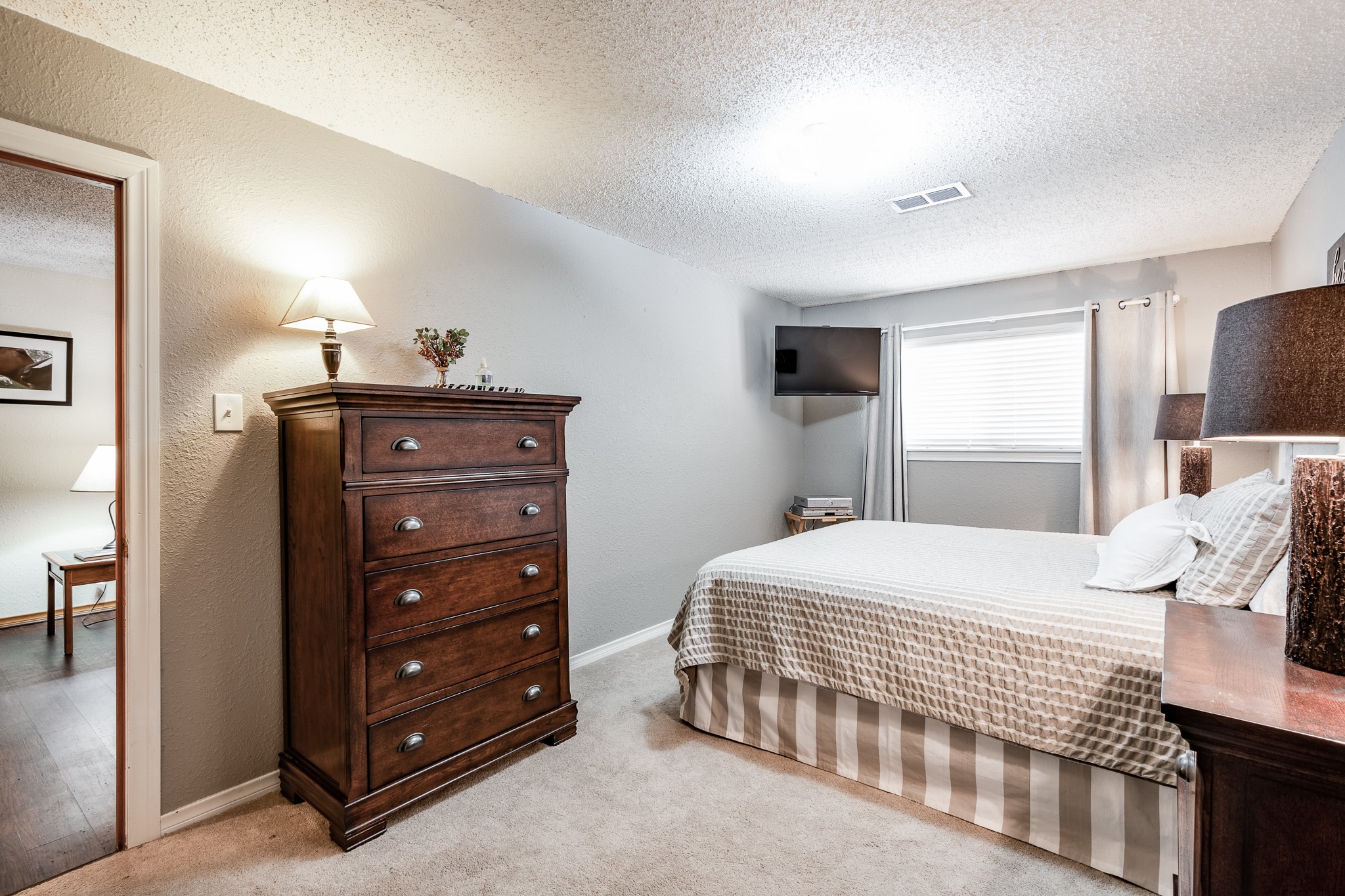 16410 Farm To Market 1485 Conroe, TX 77302 - Photo 28 of 47 a bedroom with a bed and a dresser