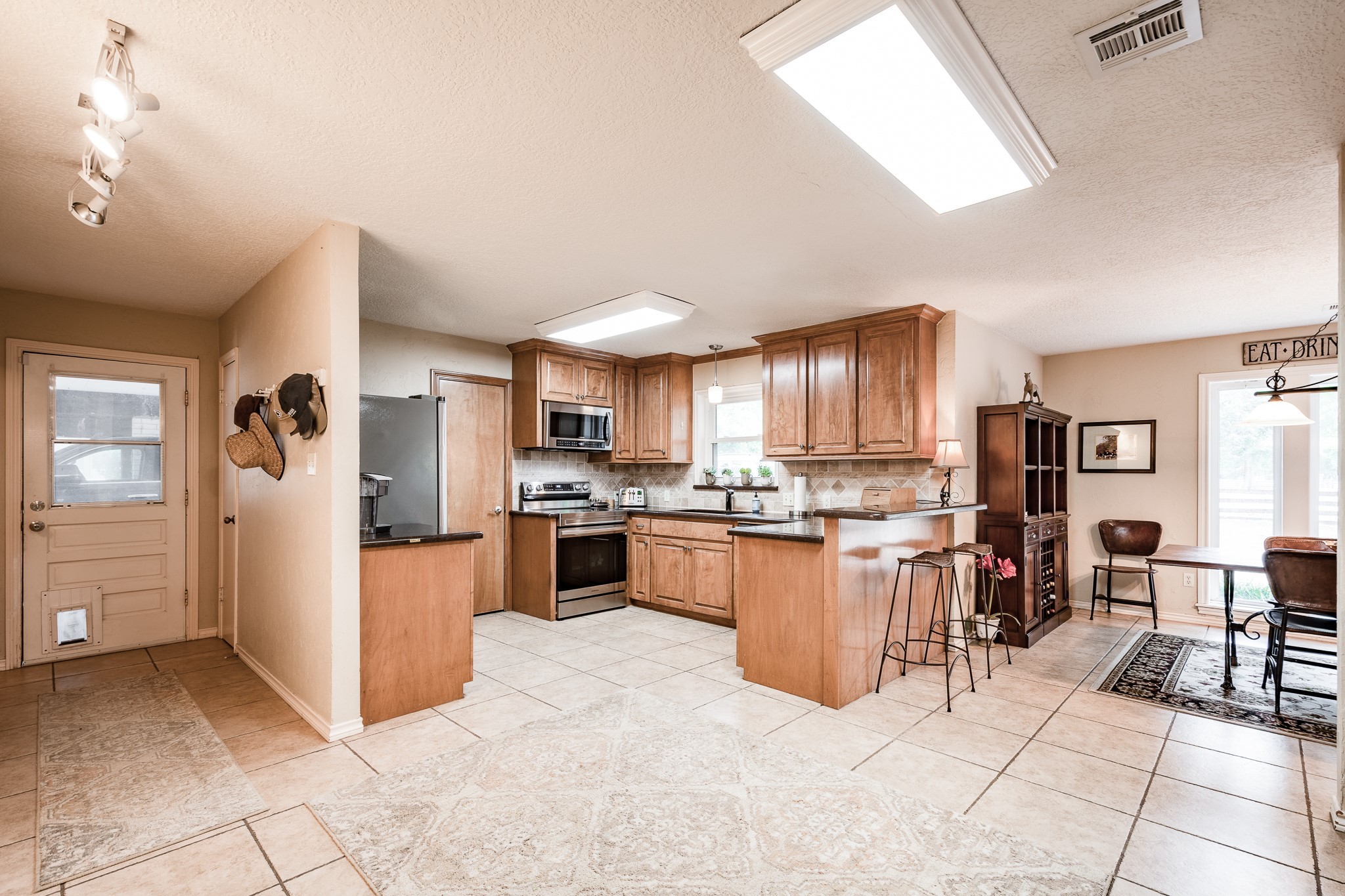 16410 Farm To Market 1485 Conroe, TX 77302 - Photo 32 of 47 a kitchen with stainless steel appliances granite countertop a refrigerator oven a sink and dishwasher