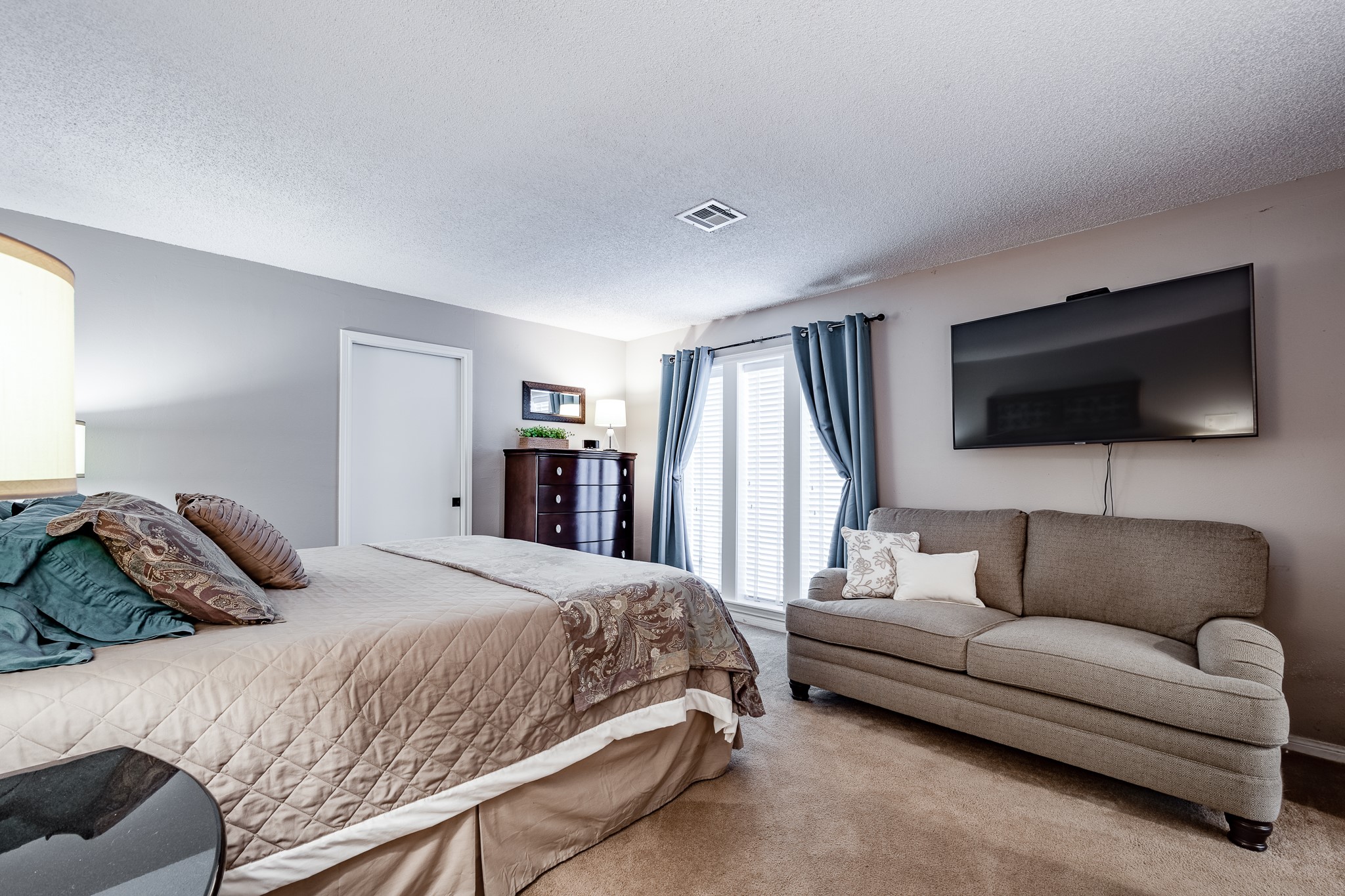 16410 Farm To Market 1485 Conroe, TX 77302 - Photo 36 of 47 a bedroom with a bed a couch and a flat screen tv