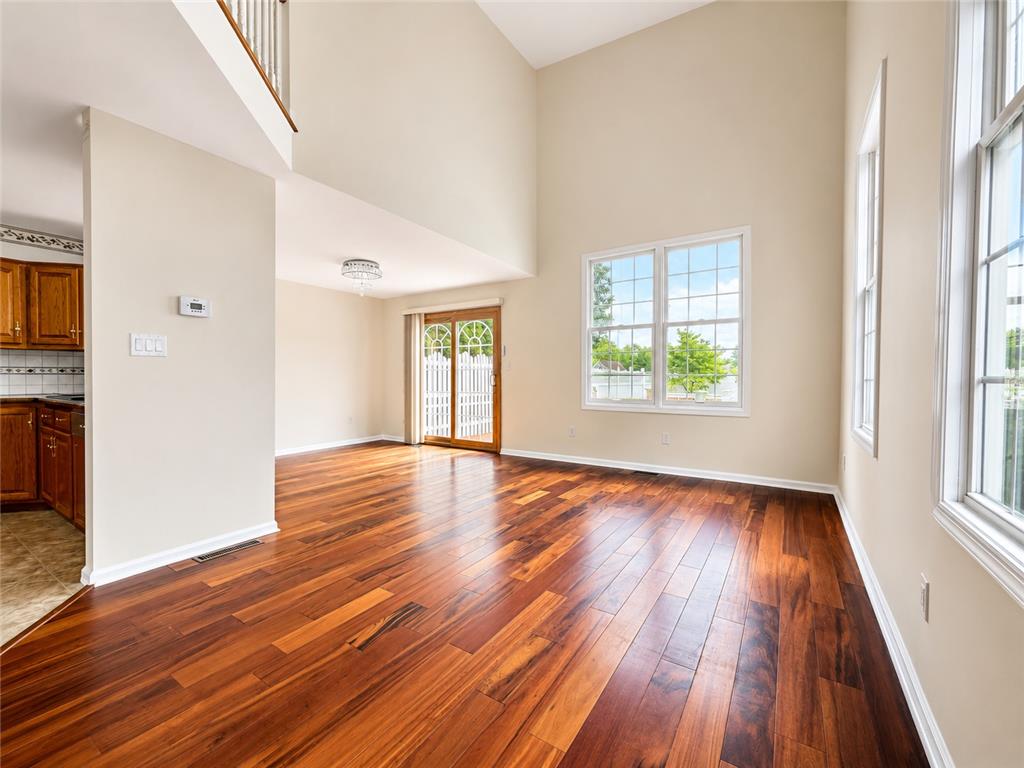 511 Howertown Road Northampton, PA 18067 - Photo 4 of 34 Rich hardwood flooring extends through this airy living area, illuminated by ample windows and a sliding glass door.