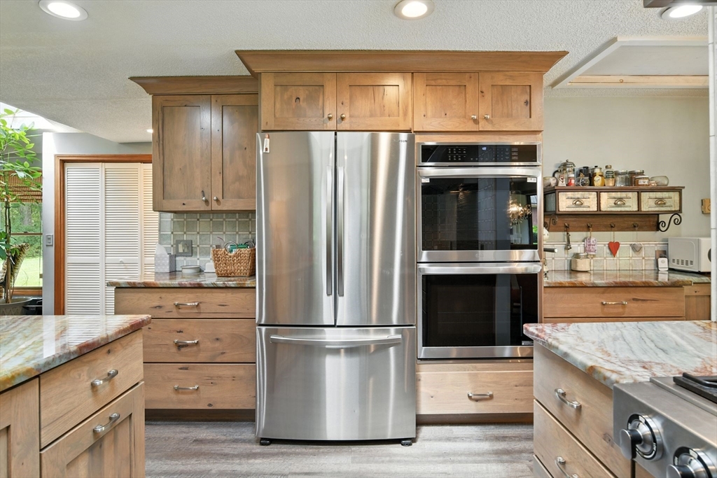 68 Stagecoach Road West Brookfield, MA 01585 - Photo 12 of 40 a kitchen with stainless steel appliances granite countertop a refrigerator and a stove top oven