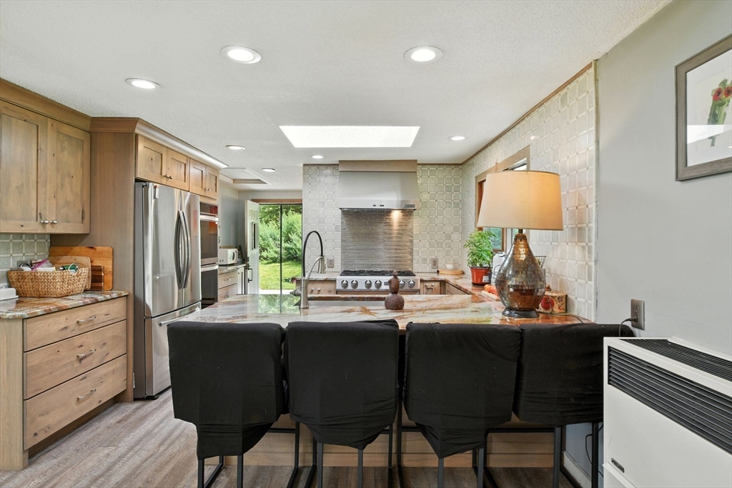 68 Stagecoach Road West Brookfield, MA 01585 - Photo 14 of 40 a kitchen with stainless steel appliances kitchen island granite countertop a sink and cabinets