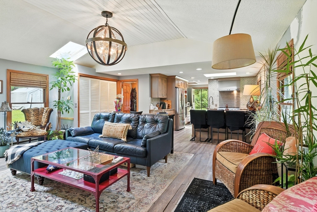 68 Stagecoach Road West Brookfield, MA 01585 - Photo 23 of 40 a living room with furniture a rug and a chandelier