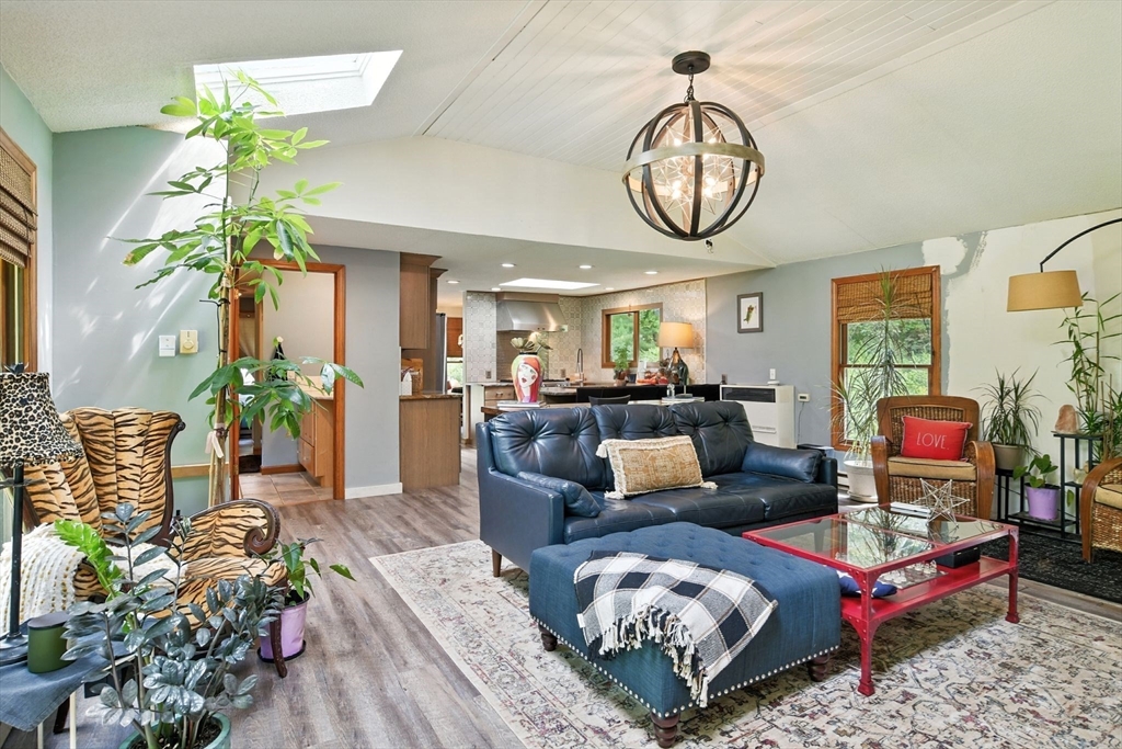 68 Stagecoach Road West Brookfield, MA 01585 - Photo 25 of 40 a living room with furniture a chandelier and a rug