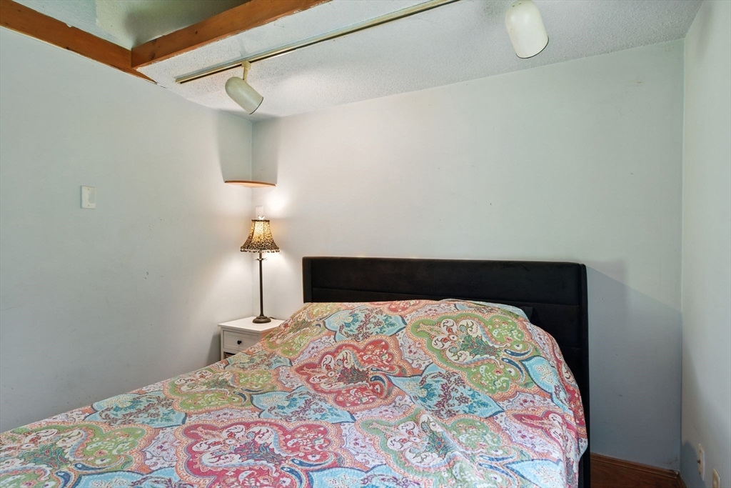 68 Stagecoach Road West Brookfield, MA 01585 - Photo 29 of 40 a bed sitting in a bedroom next to a lamp