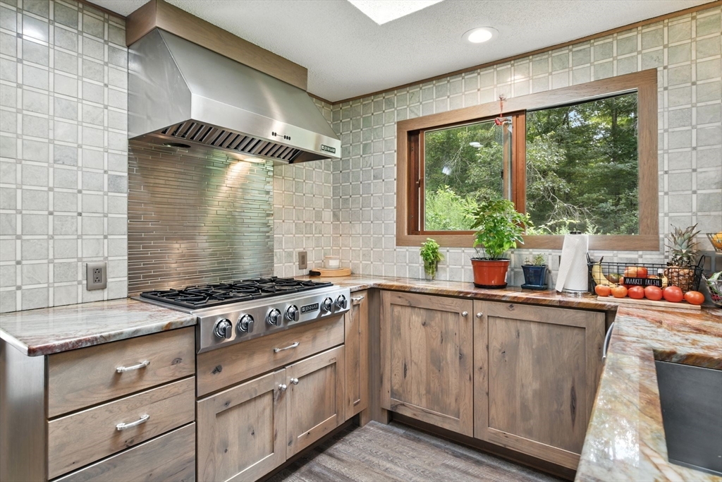 68 Stagecoach Road West Brookfield, MA 01585 - Photo 10 of 40 a kitchen with stainless steel appliances granite countertop a stove a sink and wooden cabinets