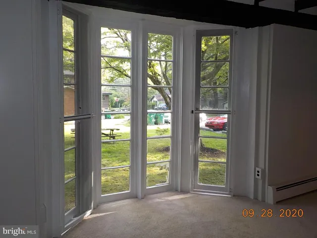 a view of an empty room with large windows