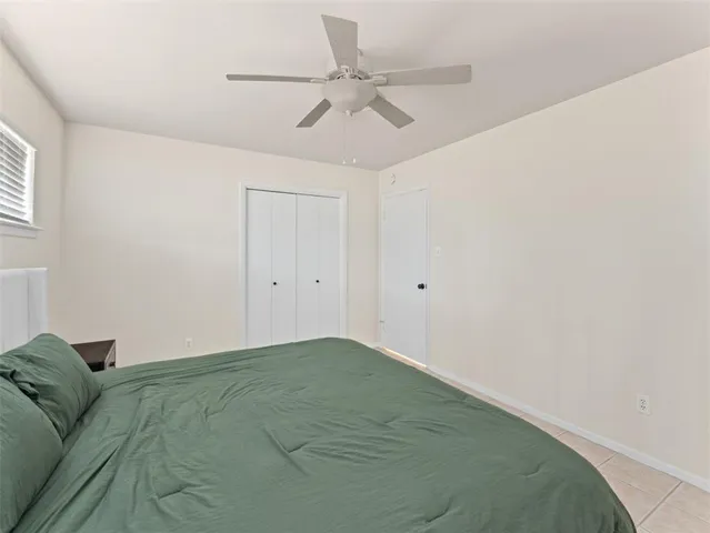 a view of a livingroom with a ceiling fan and a window