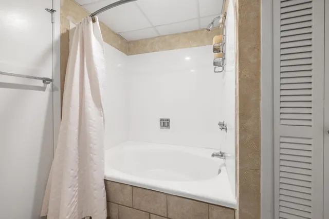 a bathroom with a bathtub and a shower