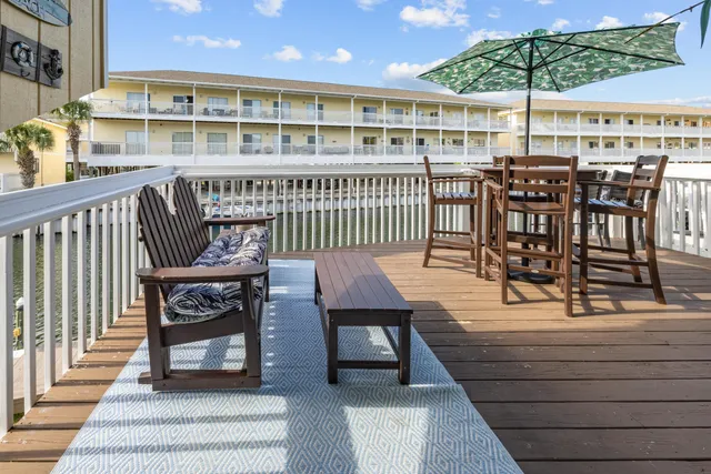 a view of a roof deck with furniture