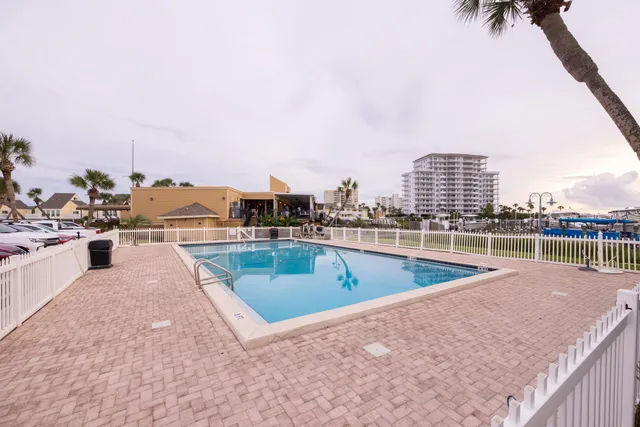 a view of a swimming pool with a lawn chairs