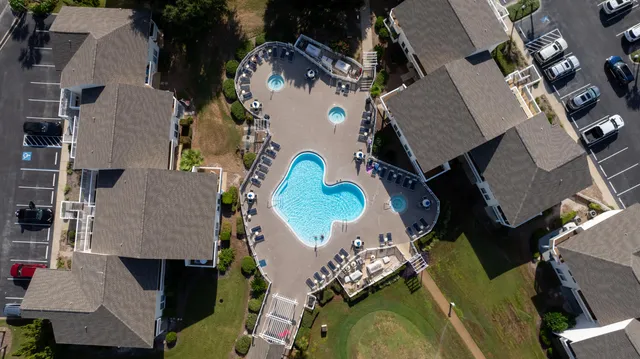 an aerial view of a house with outdoor space and parking