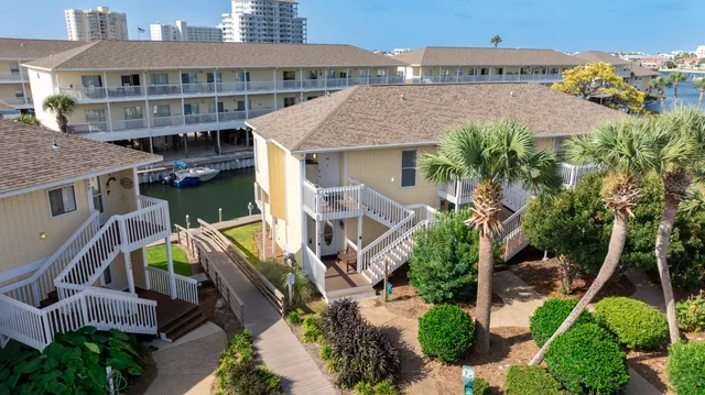 an aerial view of a house with balcony and garden