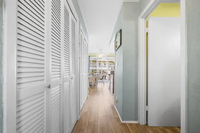 a view of a hallway with wooden floor and staircase