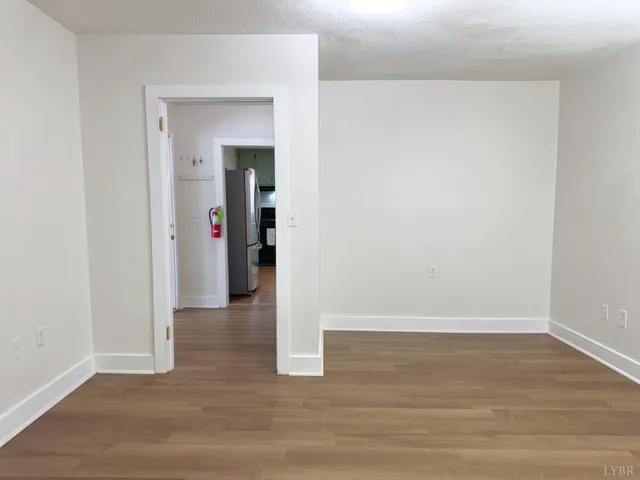 a view of a room with wooden floor