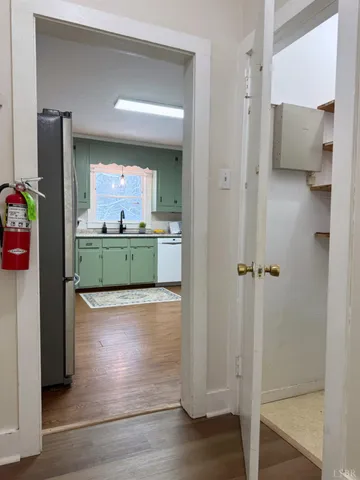 a view of kitchen with refrigerator and window
