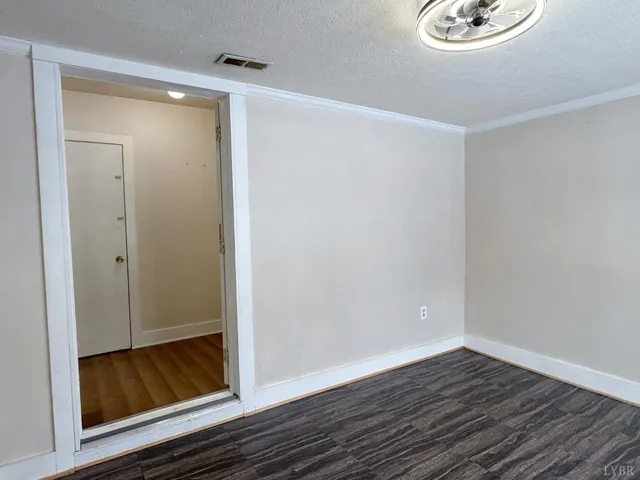 a view of room with wooden floor and front door