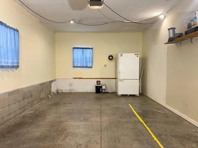 a front view of a house with yard and trees