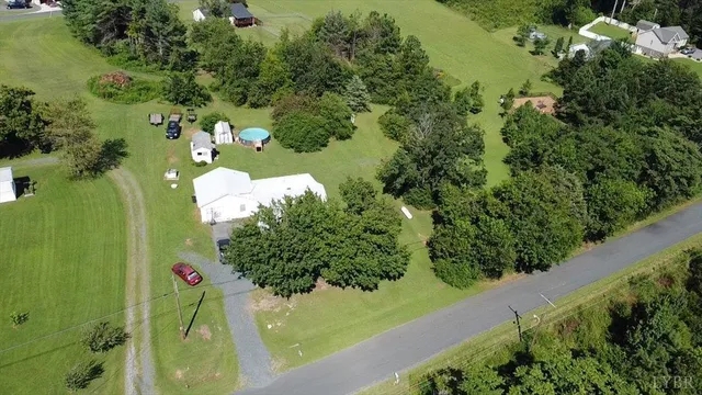 a view of a bench in the garden near a lake