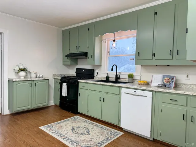 a kitchen with a sink cabinets and wooden floor