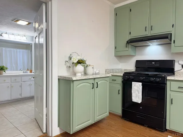 a kitchen with granite countertop a stove and a sink