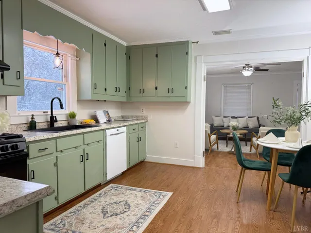 a kitchen with a sink cabinets and wooden floor