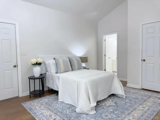 a bedroom with a bed and wooden floor