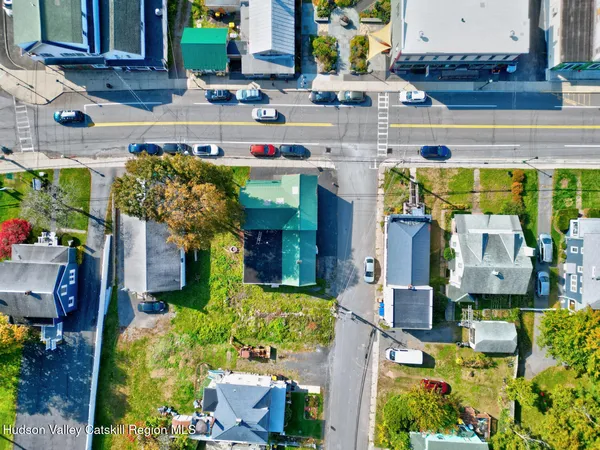 an aerial view of residential houses with outdoor space and trees