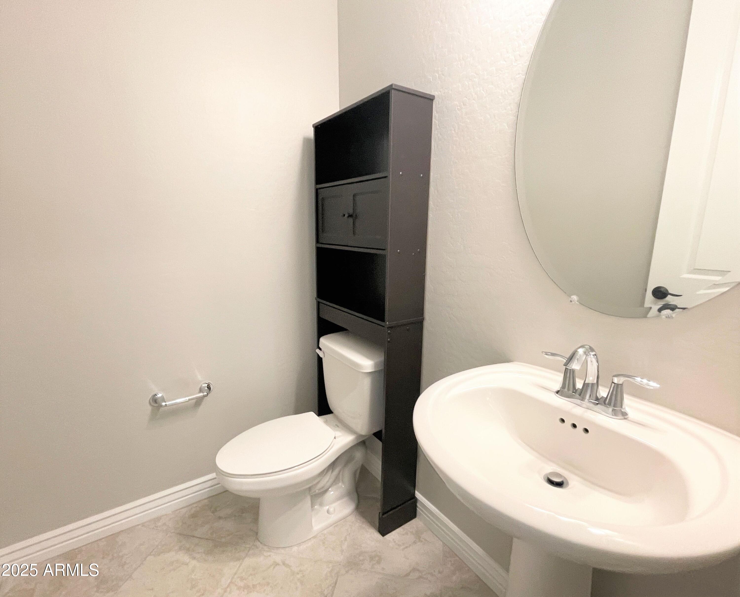21046 East Mayberry Road Queen Creek, AZ 85142 - Photo 12 of 32 a white toilet sitting next to a bathroom sink