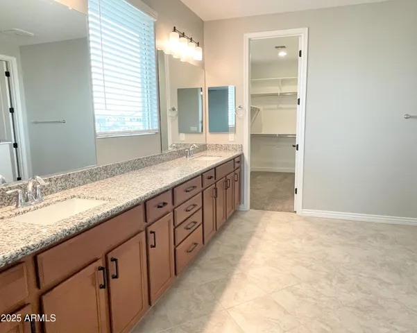 a bathroom with a granite countertop sink mirror and a