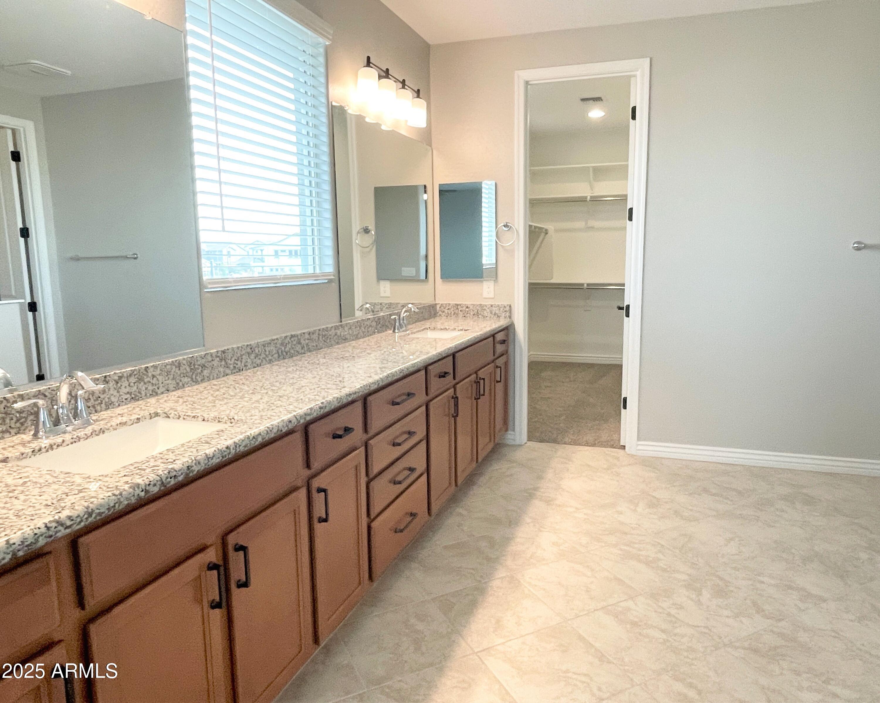 21046 East Mayberry Road Queen Creek, AZ 85142 - Photo 17 of 32 a bathroom with a granite countertop sink mirror and a