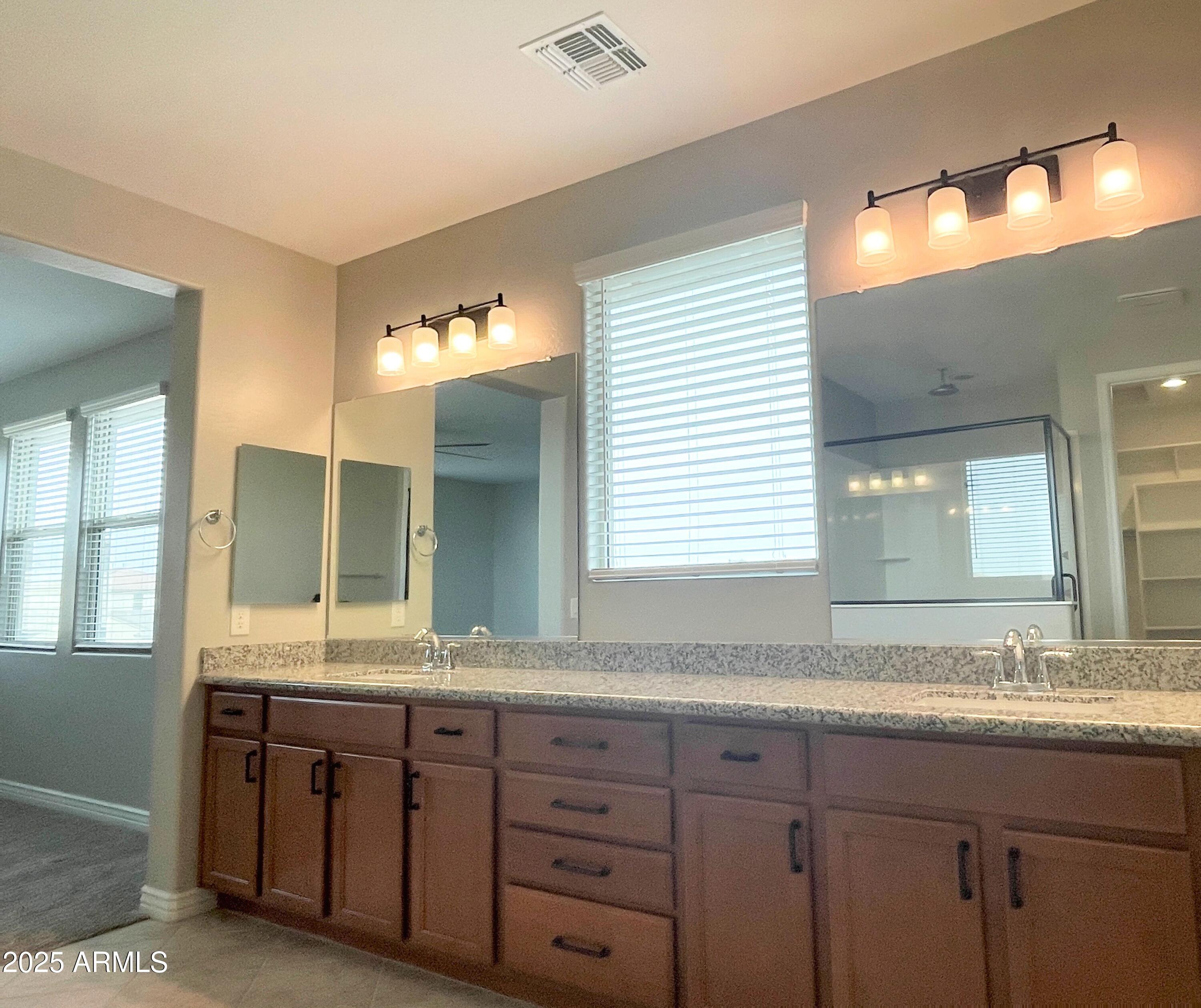 21046 East Mayberry Road Queen Creek, AZ 85142 - Photo 19 of 32 a bathroom with a granite countertop sink and a large mirror
