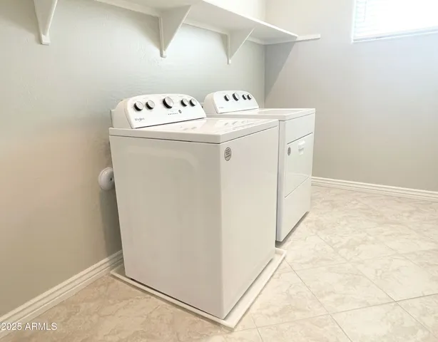 a bathroom with a granite countertop double vanity sink and mirror