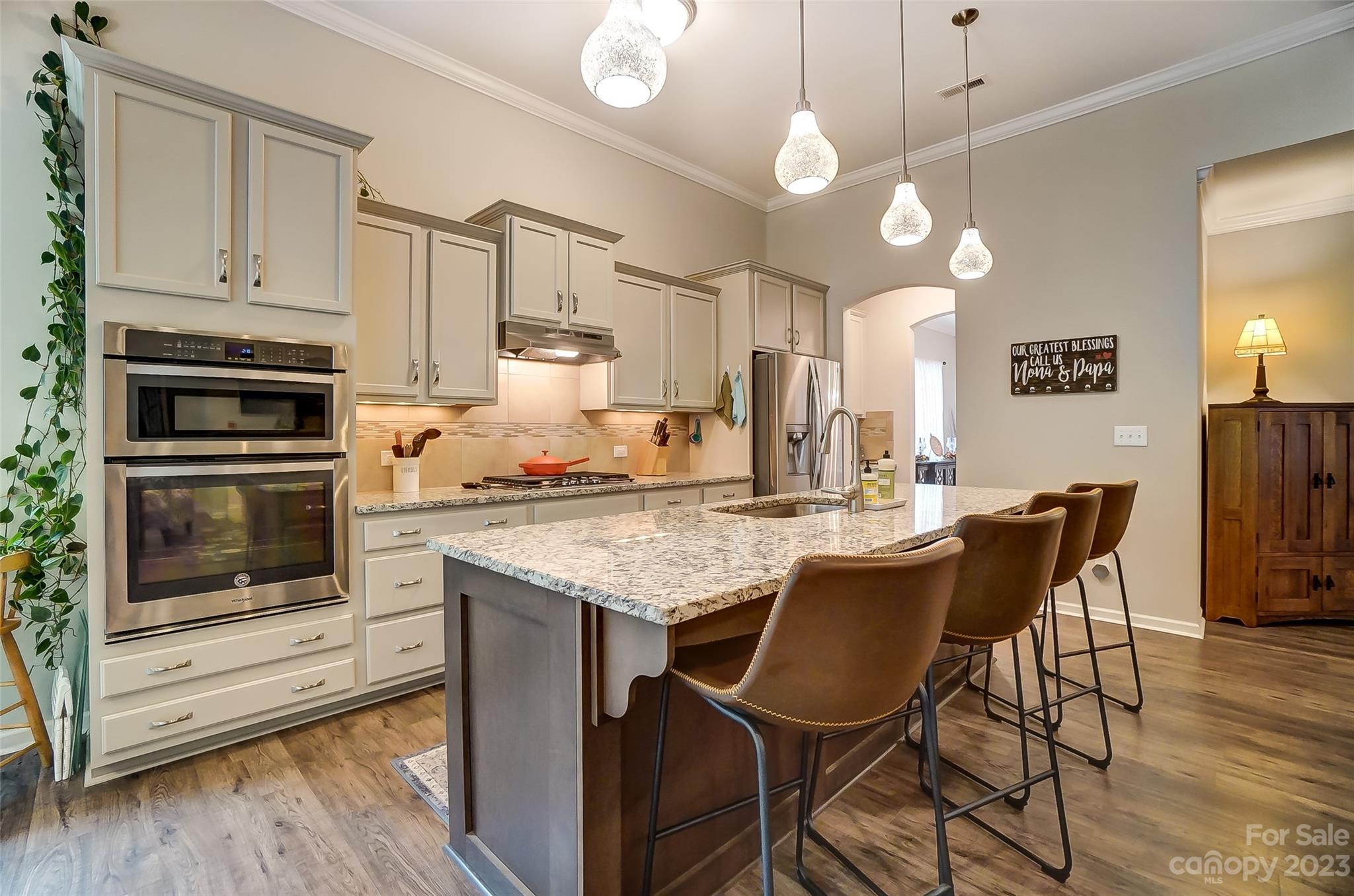 1862 Larkspur Way Tega Cay, SC 29708 - Photo 12 of 37 a kitchen with stainless steel appliances kitchen island granite countertop a table chairs and a refrigerator