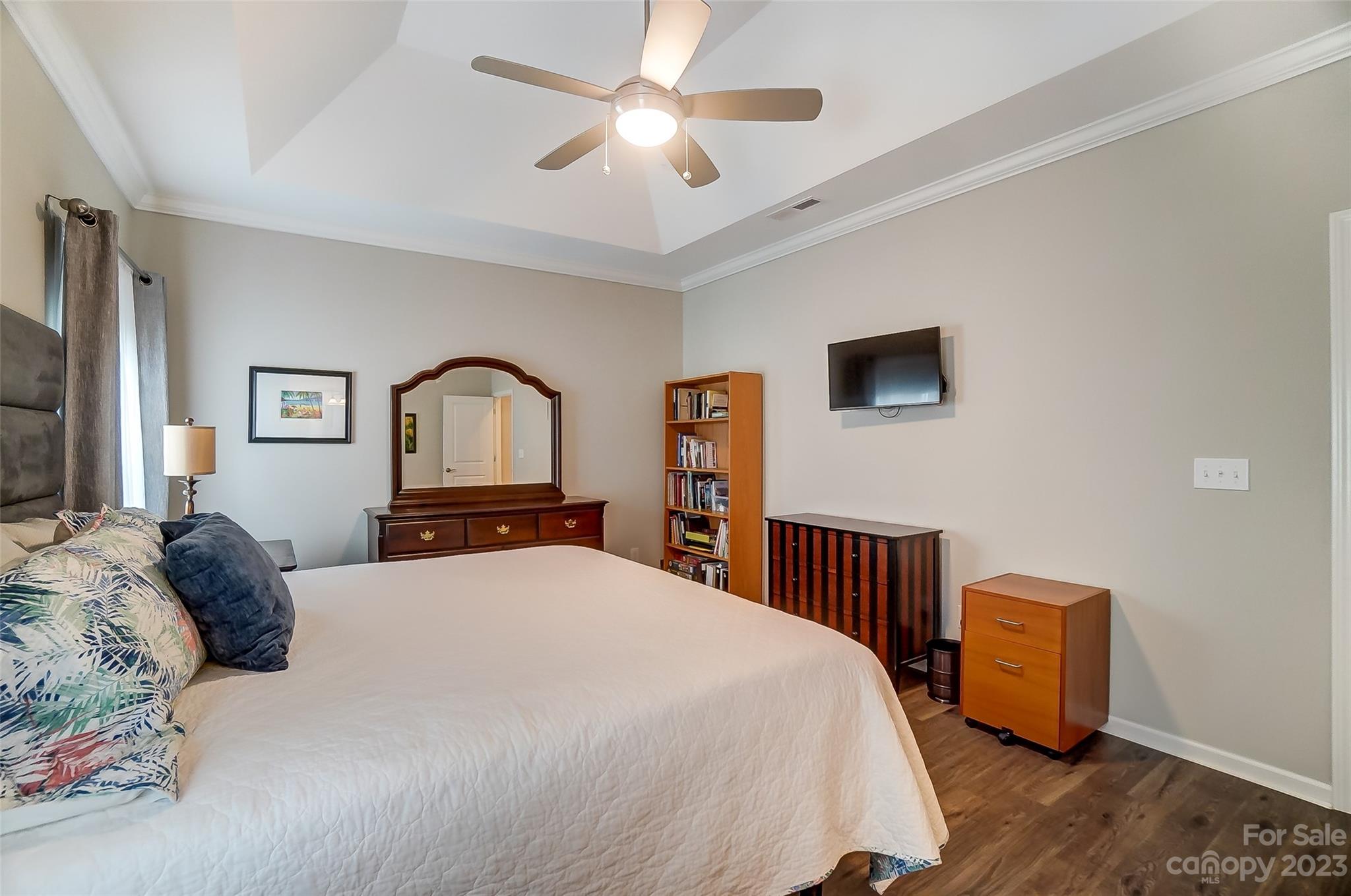 1862 Larkspur Way Tega Cay, SC 29708 - Photo 23 of 37 a bedroom with a bed chandelier and a window