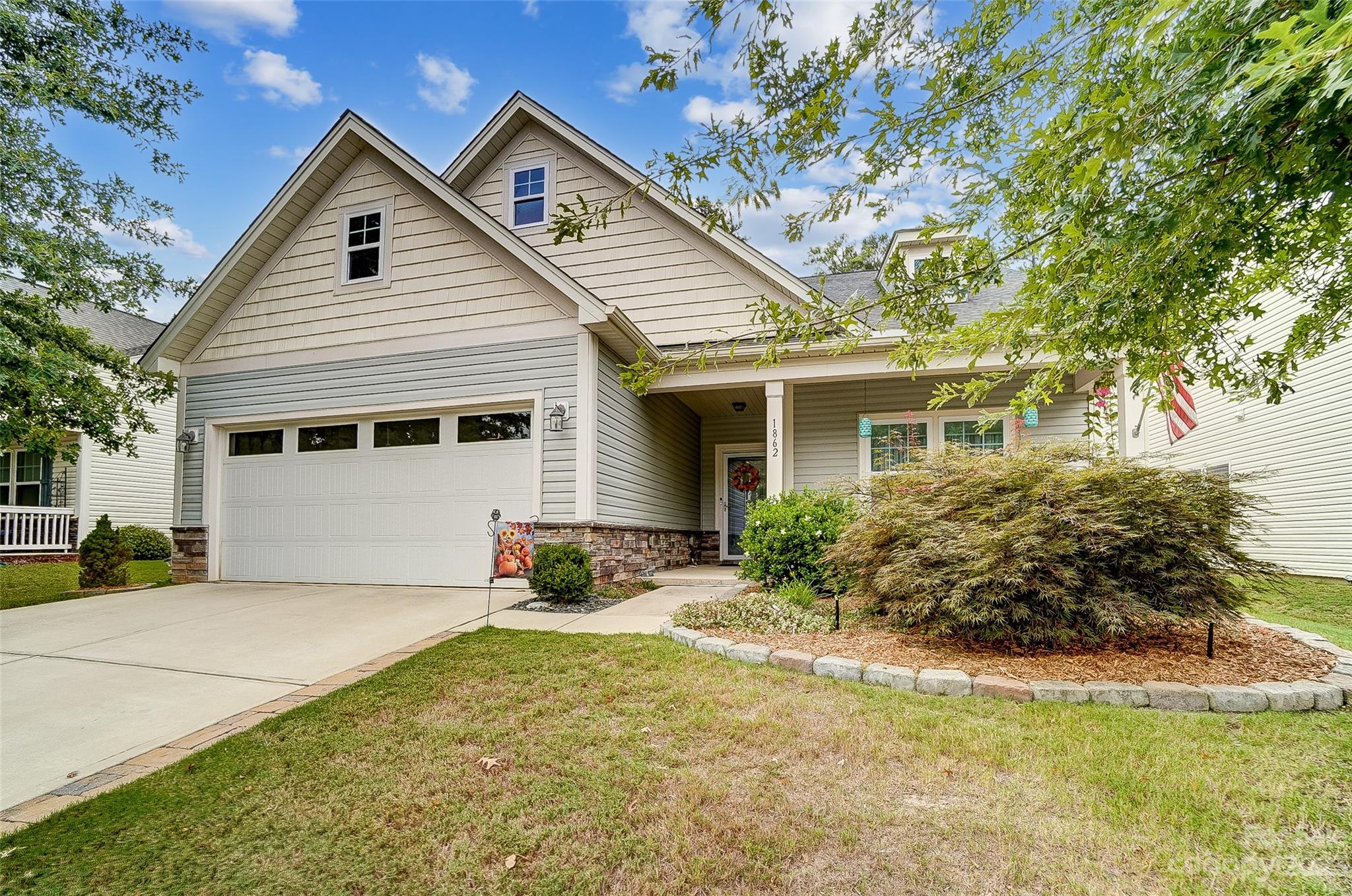 1862 Larkspur Way Tega Cay, SC 29708 - Photo 3 of 37 a front view of house with yard and trees around